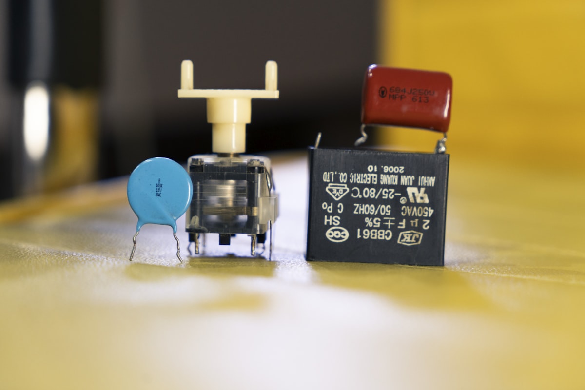 Disc, film, box style capacitors lined up on a workbench