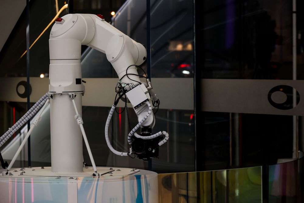 A collaborative robot arm at work with its cable dresspack