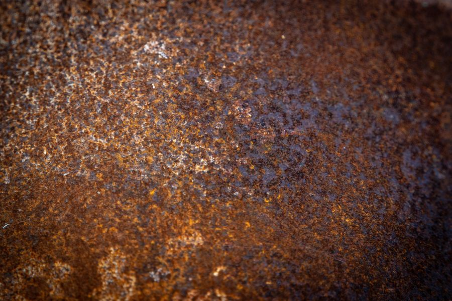 Close-up of corrosion pitting an iron surface