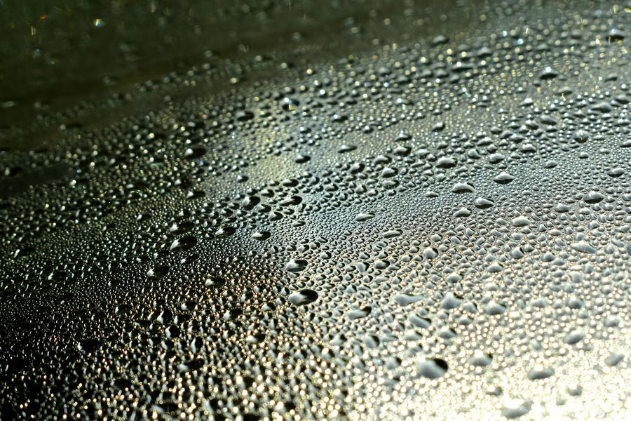 Water droplets collected across a sloped surface from condensation