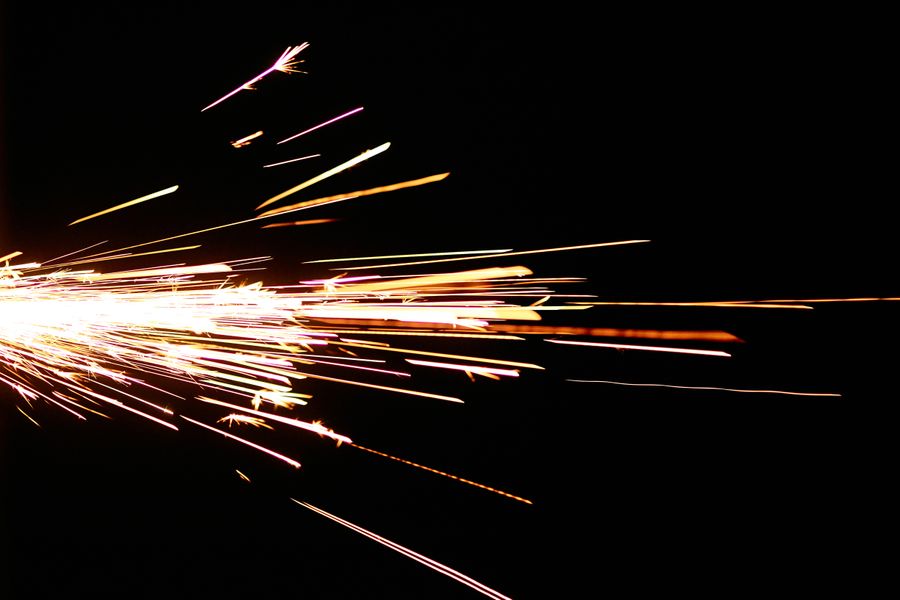 Bright sparks flying against a black background