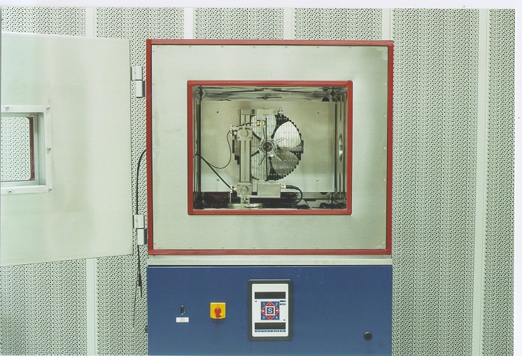 The open door of an environmental test chamber showing the interior circulation fan and the control panel below