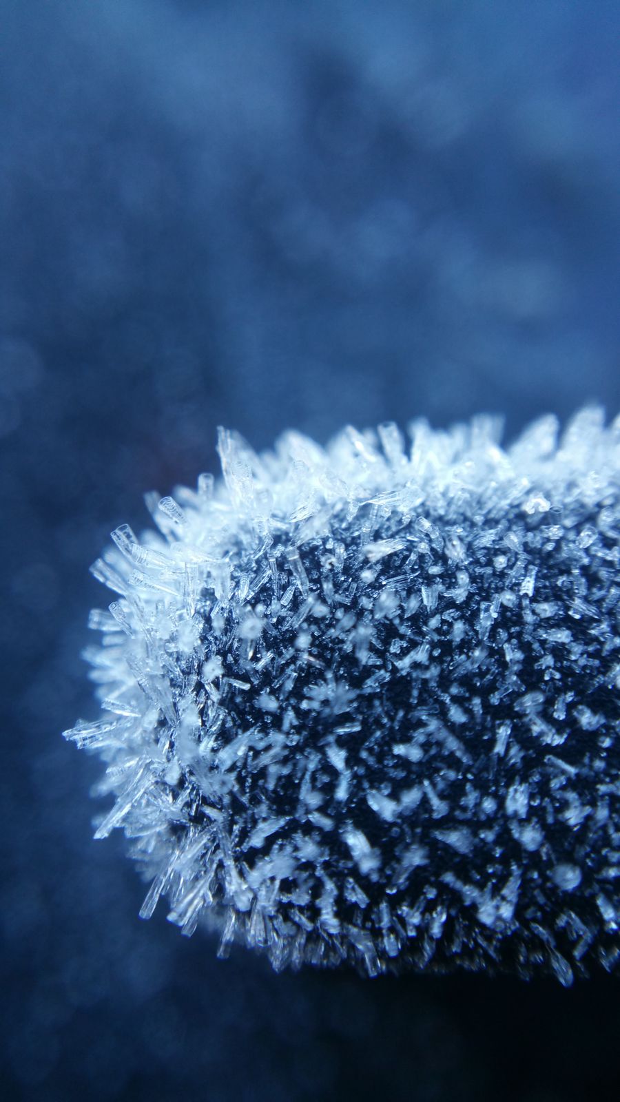 Frost ice crystals on a cold dark surface