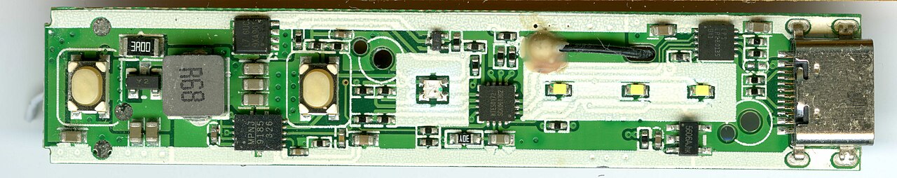 A populated printed circuit board with surface-mount components, the kind of product that goes through production burn-in