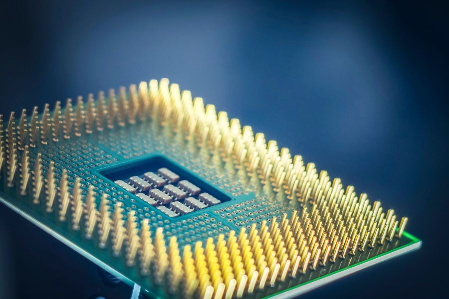 Underside of a processor chip showing its gold pin grid