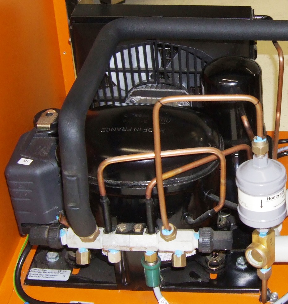 A refrigeration condensing unit with a compressor, fan, copper pipework and a filter drier
