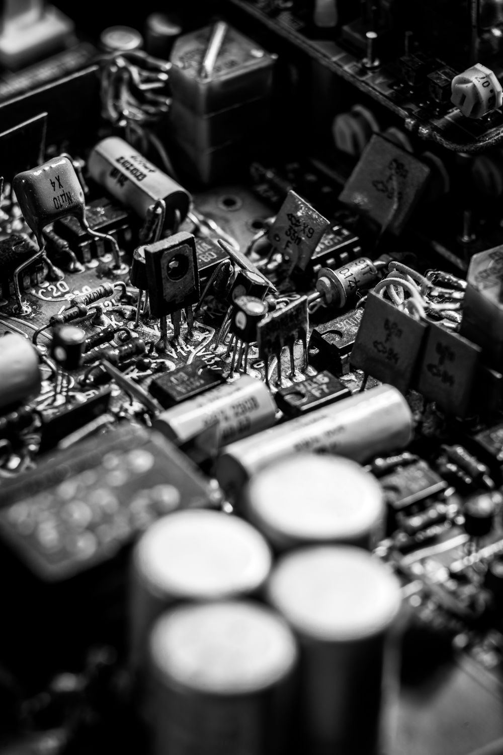 A board densely packed with soldered components in black and white