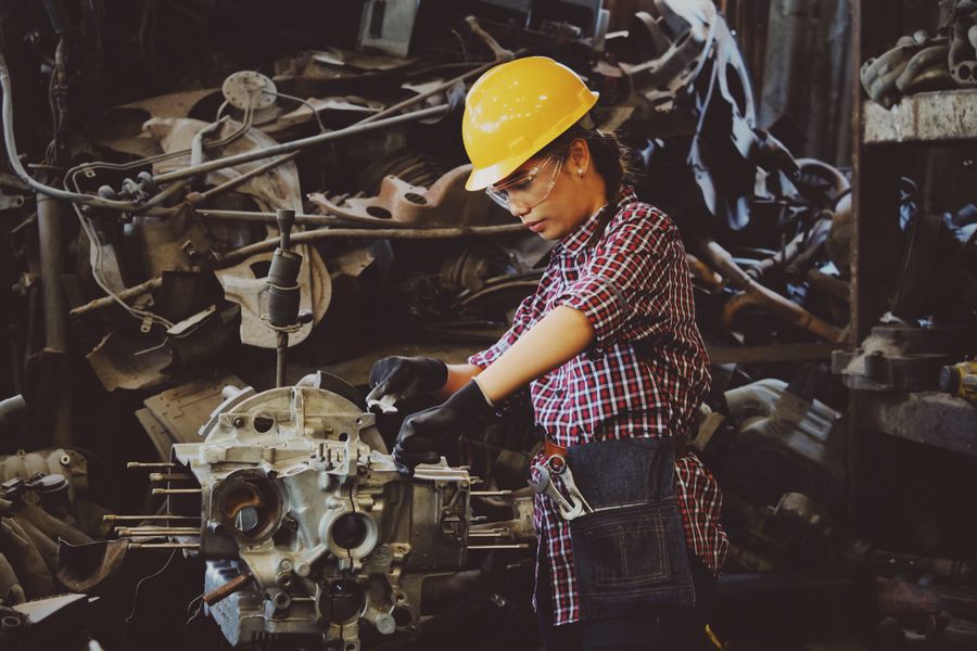 Technician stripping down a machine assembly to diagnose a fault